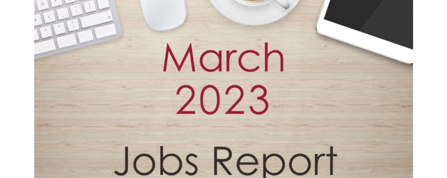 Desktop with keyboard, tablet and coffee cup, with text that reads: March 2023 Jobs Report.